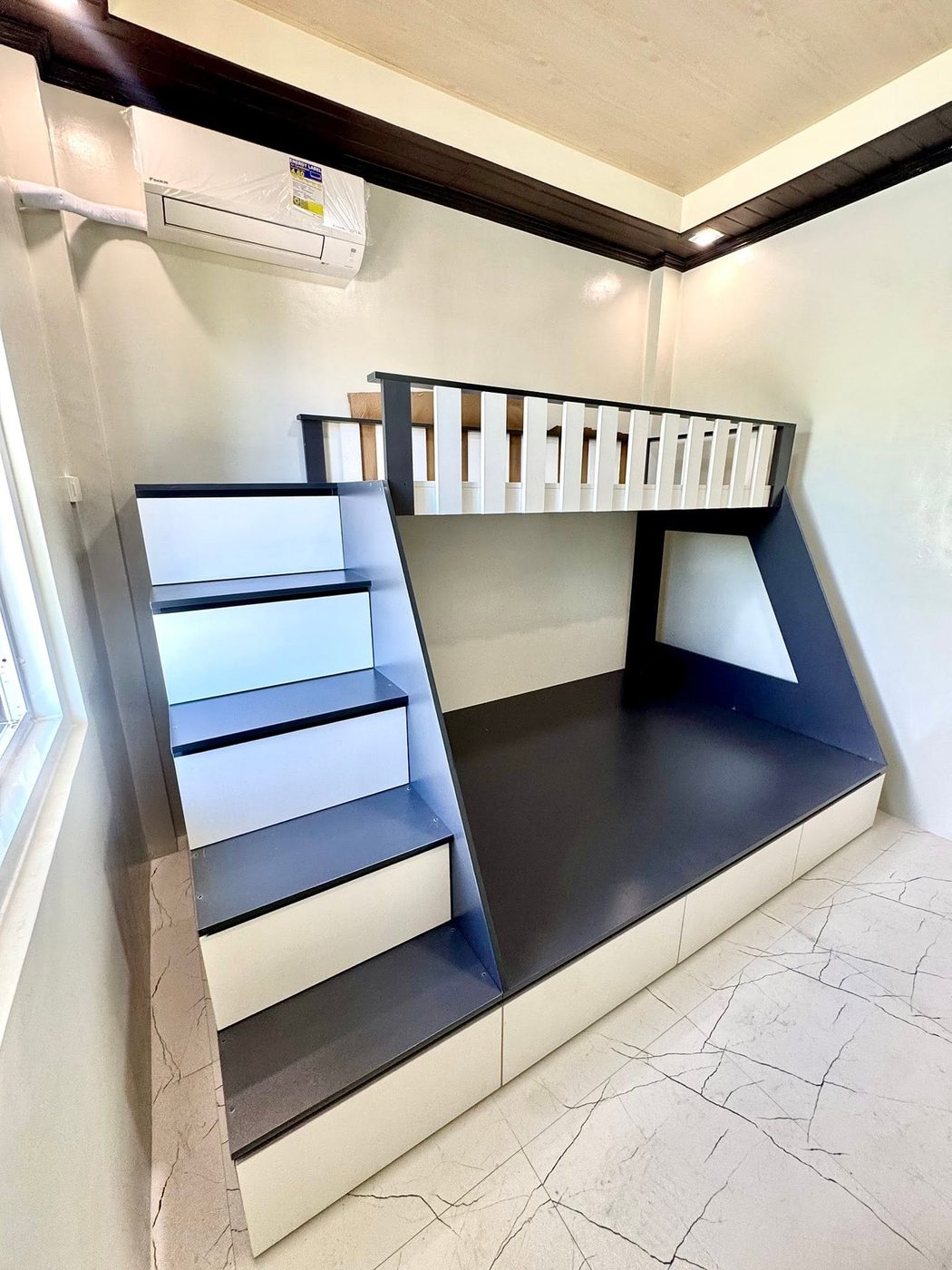 Navy and white loft bed with built-in stairs