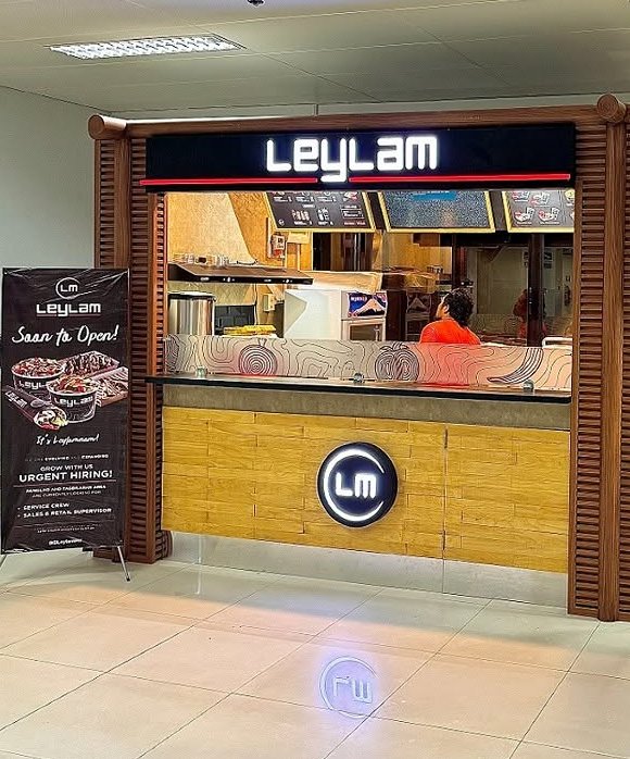 Leylam food kiosk with wood slat frame and lit signage