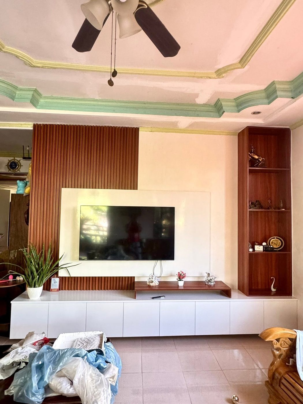 TV console wall with wood slat panel and display shelves
